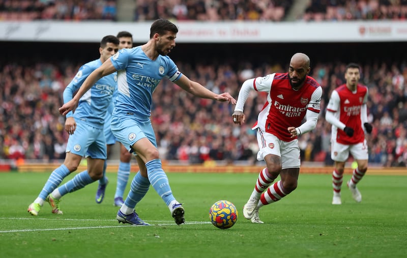 Manchester City's Ruben Dias battles with Arsenal's Alexandre Lacazette. Reuters