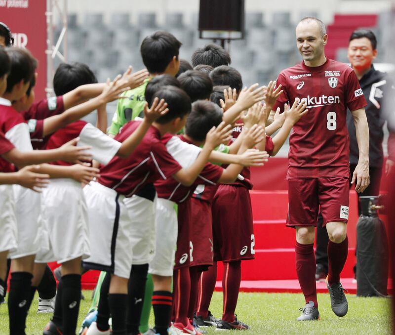 Andres Iniesta is greeted by young supporters of his new team Vissel Kobe. Reuters