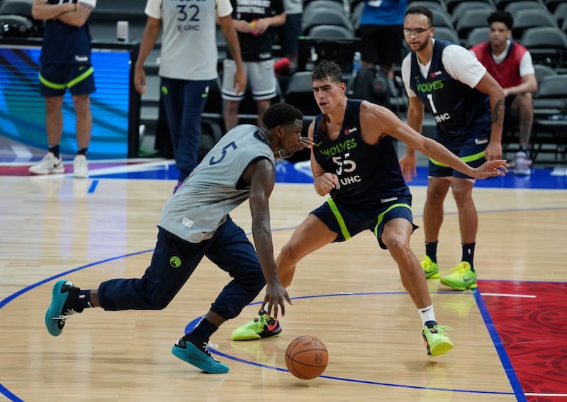 Minnesota Timberwolves Anthony Edwards, left, takes the ball around a teammate during a practice session in Abu Dhabi. AP