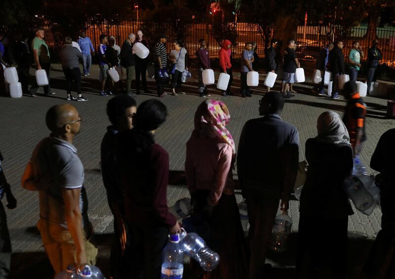 People queue to collect water from a spring in the Newlands suburb as fears over the city's water crisis grow in Cape Town, South Africa, January 25, 2018. Picture taken January 25, 2018. REUTERS/Mike Hutchings