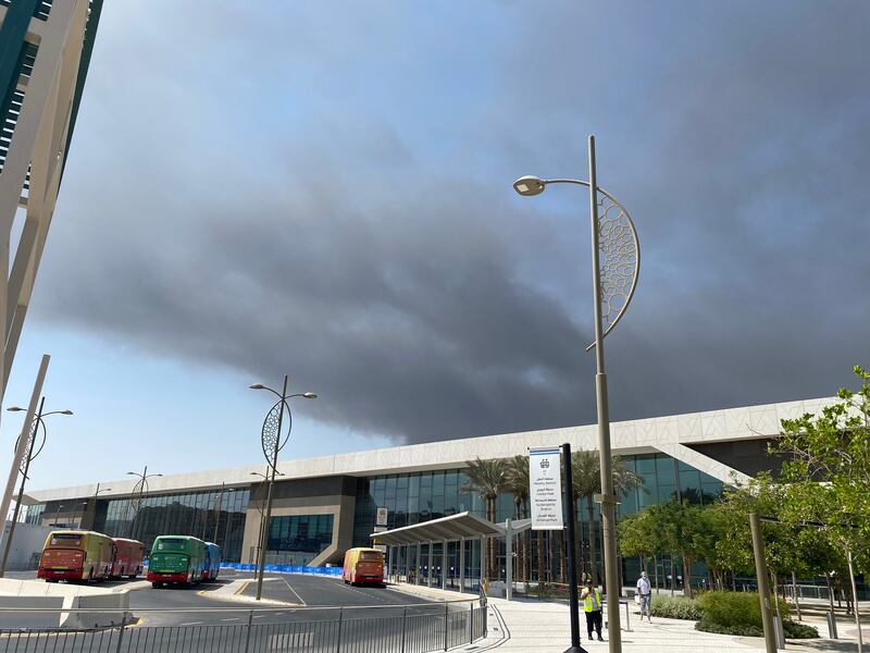 Dark clouds of smoke drift over Dubai Exhibition Centre at Expo 2020 Dubai.