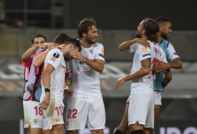 Sevilla players celebrate on the pitch. AP