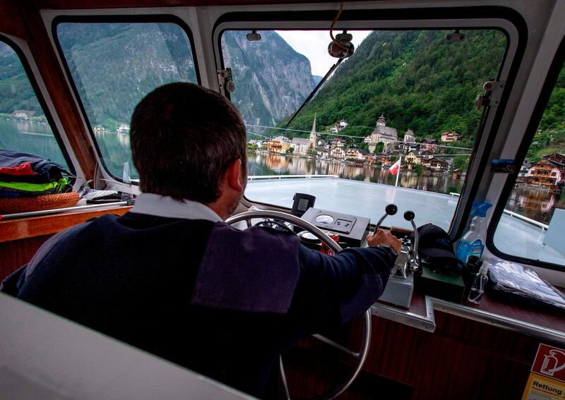 A river ship captain steers his ship towards the village of Hallstatt. AFP
