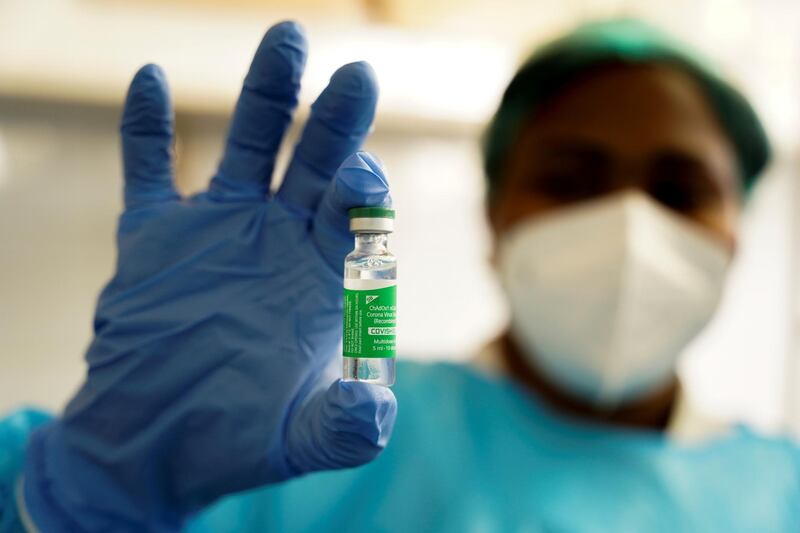 A nurse holds up a vial of the AstraZeneca coronavirus disease (COVID-19) vaccine at the Ngaliema Clinic in Kinshasa, Democratic Republic of Congo, April 29, 2021. REUTERS/Hereward Holland