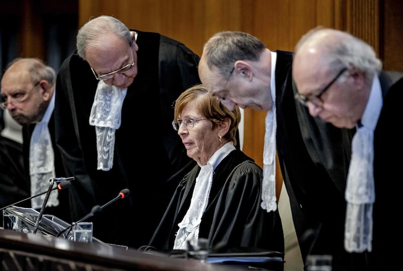 ICJ president Joan Donoghue and judges arrive at the court before the verdict announcement in The Hague on Friday. AFP