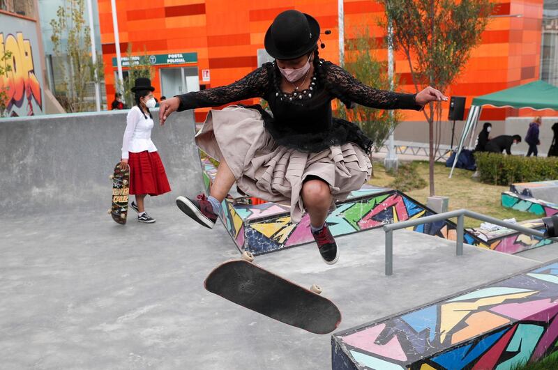 Aide Choque, wearing a mask amid the Covid-19 pandemic, jumps with her skateboard during a youth talent show in La Paz, Bolivia. Young women called "Skates Imillas," using the Aymara word for girl, use traditional Indigenous clothing as a statement of pride of their Indigenous culture when riding their skateboards. AP Photo