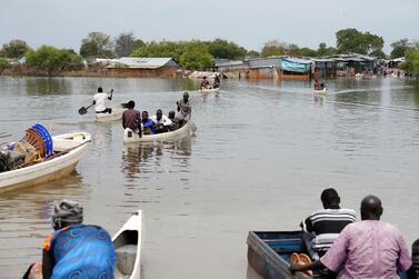 People use canoes to cross flood waters in the town of Pibor, Boma state, South Sudan, December 11, 2019. Reuters