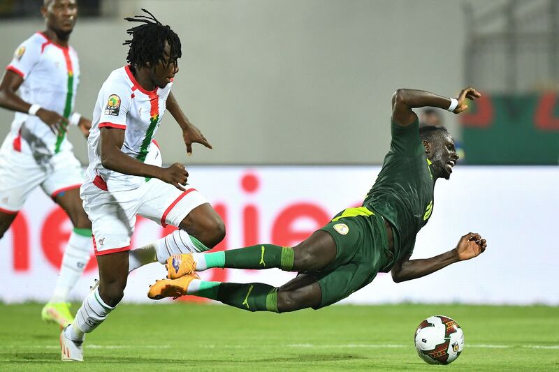 Senegal forward Sadio Mane goes down under a challenge from Burkina Faso's Issa Kabore. AFP