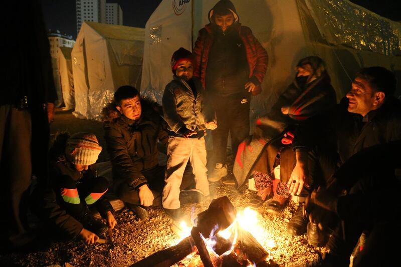 People try get warm around a fire after an earthquake hit Elazig, Turkey.  EPA