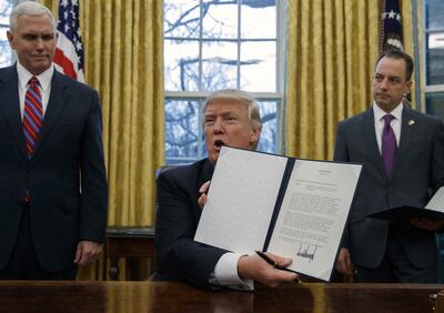 Then US president Donald Trump shows off an executive order to withdraw the country from the Trans-Pacific Partnership trade pact. AP Photo
