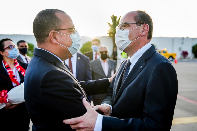 Tunisian Prime Minister Hichem Mechichi, left, greets his French counterpart Jean Castex at Tunis-Carthage Airport in Tunis, Tunisia, Wednesday, June 2, 2021. (AP Photo/Hassene Dridi)