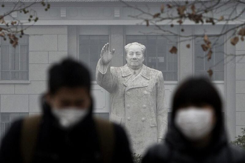 People wear masks during a hazy day in downtown Shanghai. Almost all Chinese cities monitored for pollution last year failed to meet state standards. Aly Song / Reuters