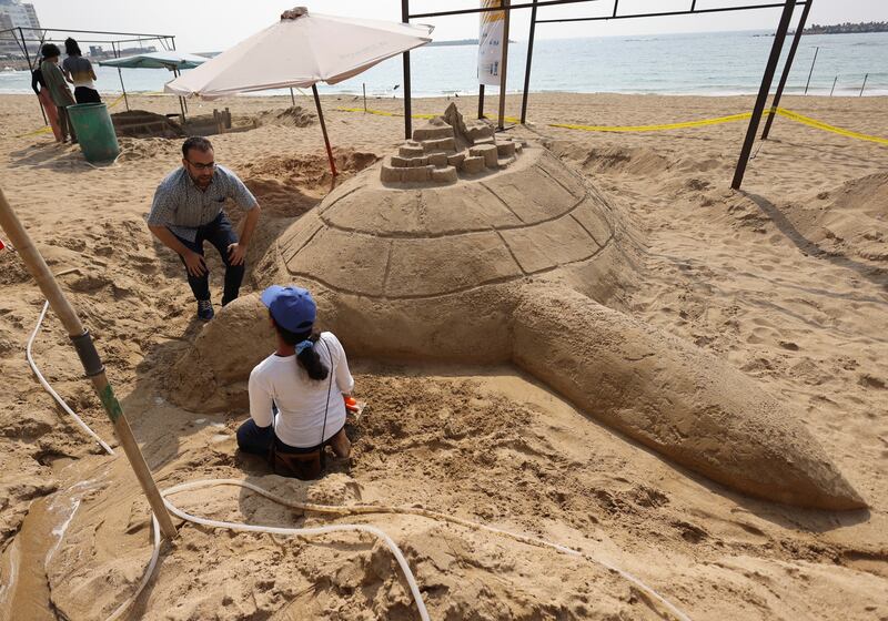 Dr  Ihab Al Sheikh, fine arts professor at Alexandria University, talks with student Nansy Khaled as she builds 'Citadel on the Sea Turtle'