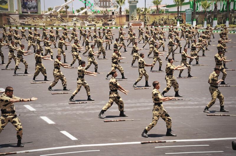 In this image released by the Egyptian President, Egyptian military soldiers perform during a medal ceremony, at a military base east of Cairo, Egypt, Thursday, July 5, 2012. A Palestinian official says Gaza's prime minister will head to Cairo within the next two weeks to meet with Egypt's new Islamist president, who has close ties with the territory's Hamas rulers. (AP Photo/Mohammed Abd El Moaty, Egyptian Presidency)
