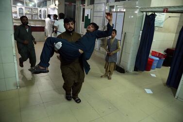 An Afghan man who was injured when militants attacked a prison in Jalalabad on Sunday is carried to hospital. EPA