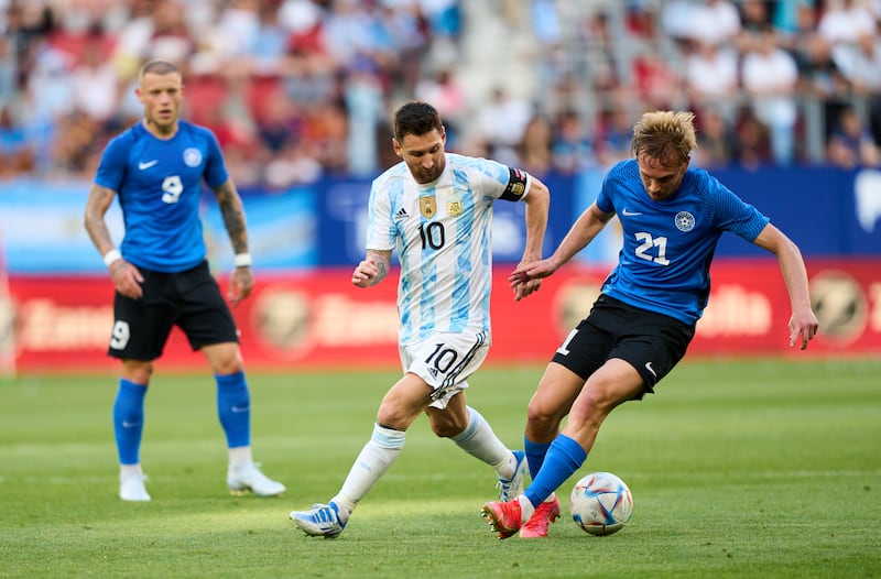 Lionel Messi of Argentina duels for the ball with Miller Martin of Estonia. Getty Images