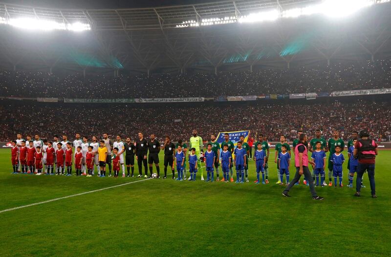 Iraq and Saudi Arabia line up prior to kick off. Iraq has not played full internationals on home turf since 1990. Haidar Mohammed Ali / AFP
