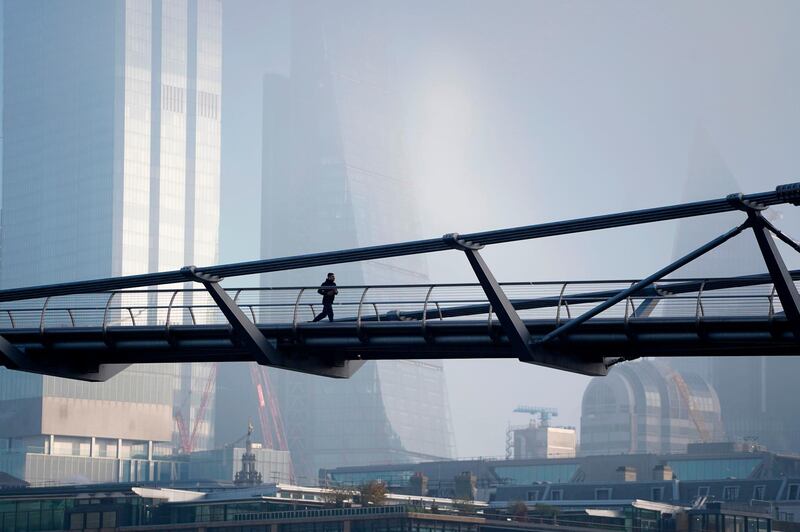 A jogger crosses the near-deserted Millennium Bridge in London. AFP