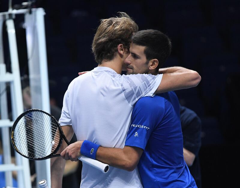 Novak Djokovic hugs Alexander Zverev after winning their group stage match at the ATP Finals tennis tournament in London. EPA