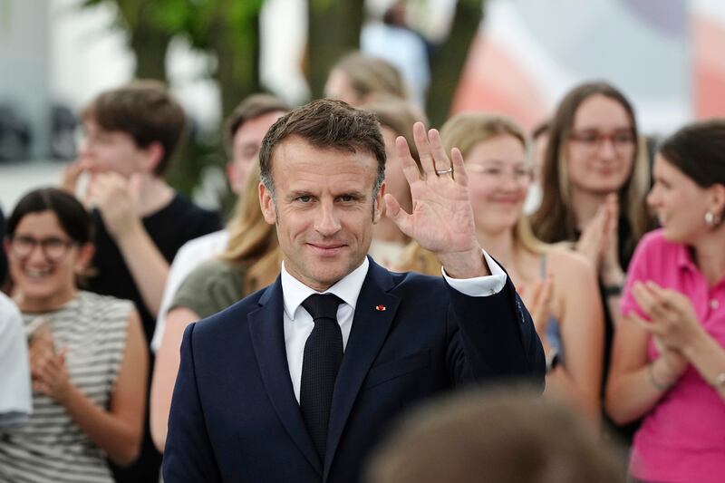 Mr Macron receives applause. AP