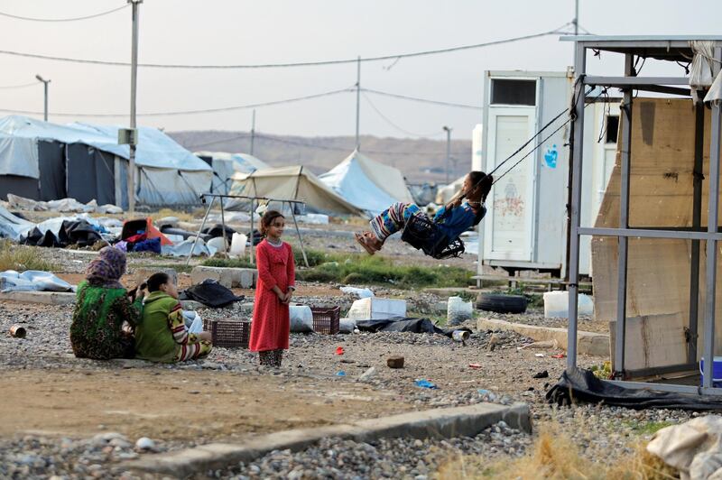 A girl plays on a swing at the Hammam Al Alil camp as displaced Iraqis prepare to be moved out. Reuters