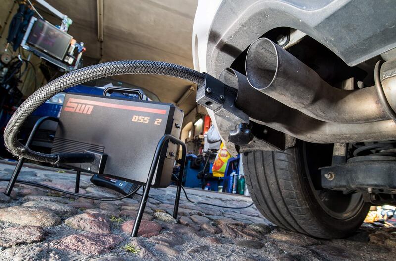 (FILES) In this file photo taken on October 01, 2015 a measuring hose for emissions inspections in diesel engines sticks in the exhaust tube of a Volkswagen (VW) Golf 2,0 TDI diesel car at a garage in Frankfurt an der Oder, eastern Germany. - The first major court case against Volkswagen over its cheating of emissions tests on 11 million diesel vehicles worldwide begins on September 10, 2018. (Photo by PATRICK PLEUL / DPA / AFP)