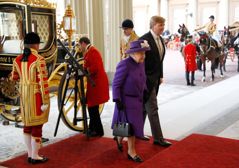 King Willem-Alexander of the Netherlands, right, and Britain's Queen Elizabeth II, left, arrive at Buckingham Palace after a Ceremonial Welcome on Horse Guards Parade in London. Peter Nicholls / AFP