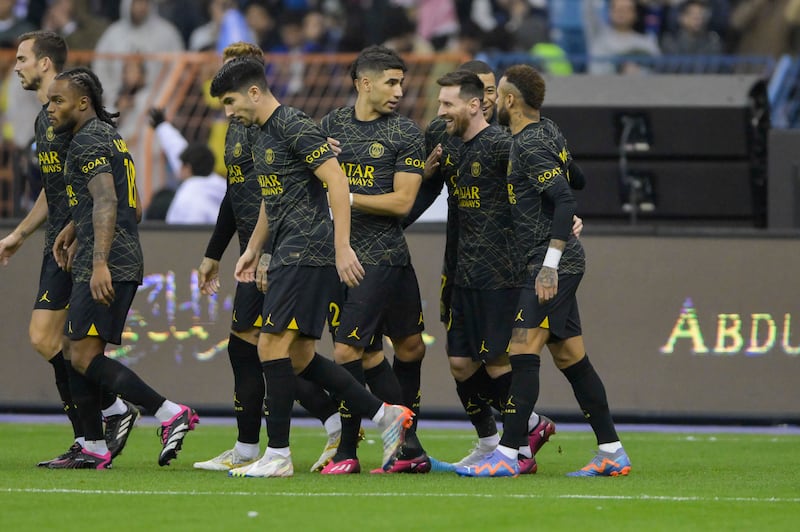 Lionel Messi is congratulated by his PSG teammates after opening the scoring. 