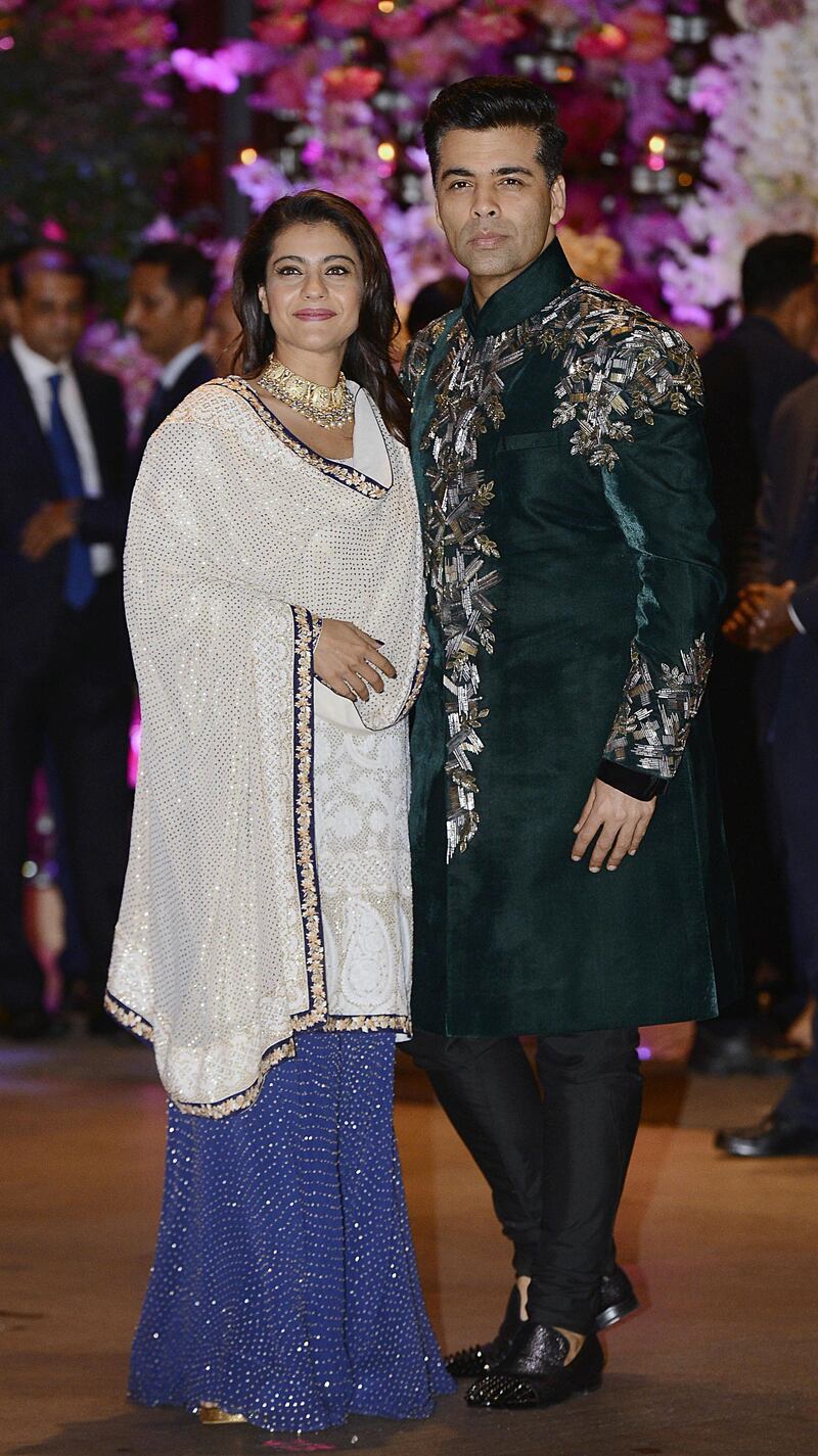 Indian Bollywood actress Kajol Devgn and director-producer Karan Johar arrive at the engagement party. AFP