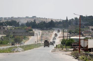 A joint Russian-Turkish patrol passes through the M4 highway on the outskirts of the rebel town of Ariha in Idlib, May 7, 2020. AFP