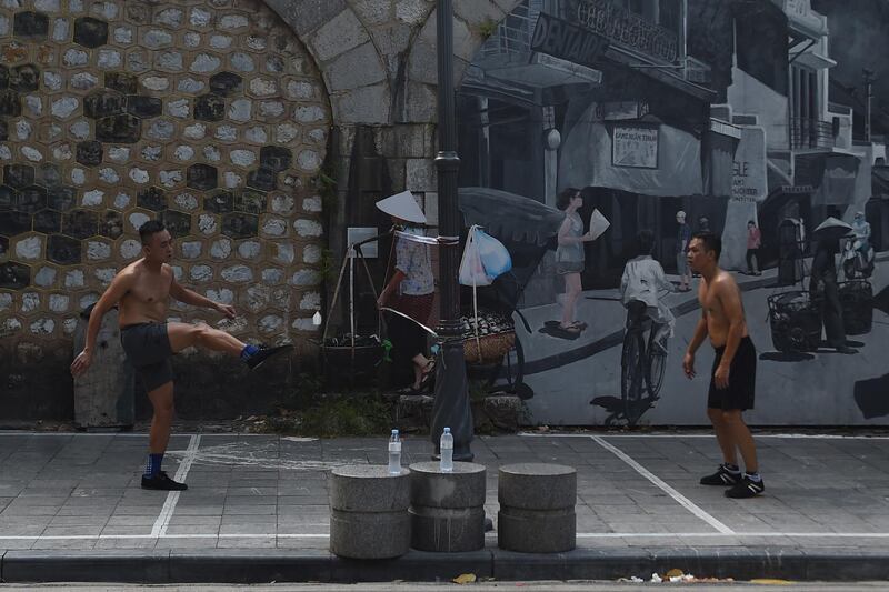 Men playing foot badminton on the streets of Hanoi, Vietnam on Friday, July 24. AFP