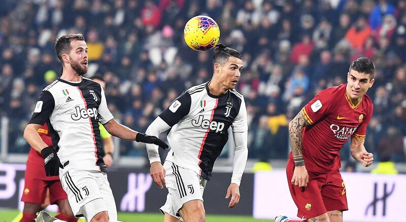 Left to right: Juventus' Miralem Pjanic and  Cristiano Ronaldo battle for possession with Gianluca Mancini of Roma. EPA