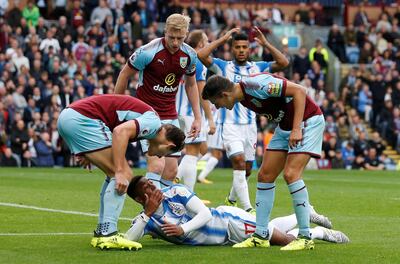 Soccer Football - Premier League - Burnley vs Huddersfield Town - Turf Moor, Burnley, Britain - September 23, 2017   Burnley's James Tarkowski and Matthew Lowton react to Huddersfield Town’s Rajiv van La Parra going down   Action Images via Reuters/Ed Sykes    EDITORIAL USE ONLY. No use with unauthorized audio, video, data, fixture lists, club/league logos or "live" services. Online in-match use limited to 75 images, no video emulation. No use in betting, games or single club/league/player publications. Please contact your account representative for further details.