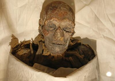 (FILES) In this file photo taken on June 27, 2007, the mummified remains of Queen Hatshepsut, ancient Egypt's most famous female pharaoh, lie in a glass case after being unveiled at the Cairo Museum. The mummies of 18 ancient Egyptian kings and four queens will be paraded through the streets of Cairo on April 3 evening, in a carnival procession dubbed the Pharaohs' Golden Parade, as they are moved from a long residency at the Egyptian Museum to be put on display at southern Cairo's National Museum of Egyptian Civilisation. / AFP / Cris BOURONCLE
