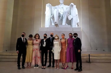 President Joe Biden and first lady Jill Biden pose for a photo with family members at the Celebrating America concert at the Lincoln Memorial in Washington, Wednesday, Jan. 20, 2021, after his inauguration.. (Joshua Roberts/Pool photo via AP)