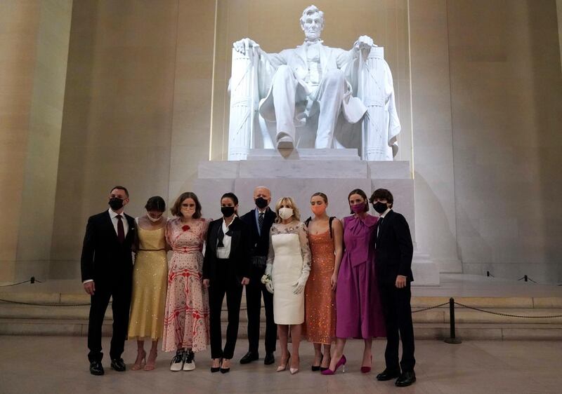 President Joe Biden and first lady Jill Biden pose for a photo with family members at the Celebrating America concert at the Lincoln Memorial in Washington, Wednesday, Jan. 20, 2021, after his inauguration.. (Joshua Roberts/Pool photo via AP)