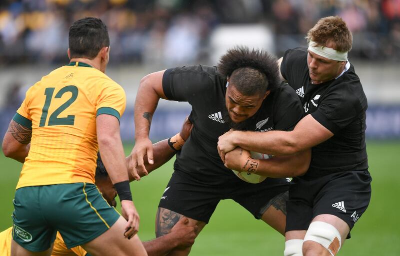 New Zealand's Ofa Tuungafasi, centre, is assisted by teammate Sam Cane, right, as they run at Australia's Matt To'omua during the Bledisloe Cup rugby game between the All Blacks and the Wallabies in Wellington, New Zealand. AP Photo