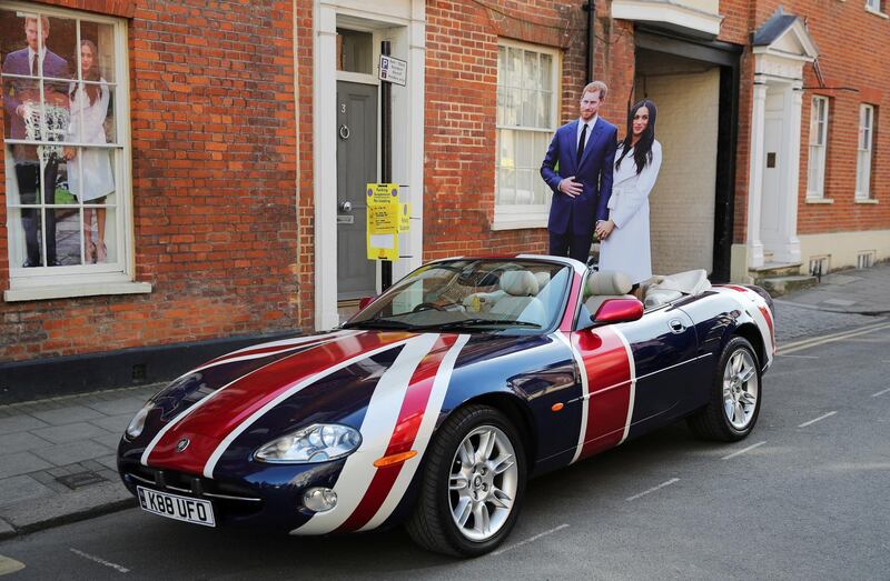 Cardboard cut-outs of Prince Harry and Meghan Markle sit in the back seat of a Jaguar convertible with a Union Flag livery in Windsor, southern England. Marko Djurica / Reuters