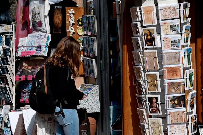 A tourist looks at a souvenirs shop in Vinci. AFP