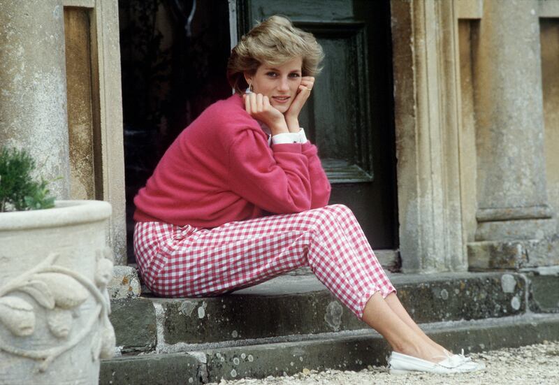 Princess Diana sits on a step at her home, Highgrove House, in Doughton, Gloucestershire, in 1986. Getty