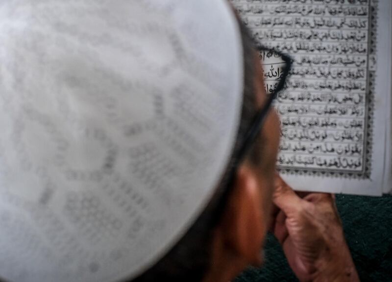 A man reads the Quran Sultan Mahmmud Baddarudin Mosque in Palembang, South Sumatra province. AFP