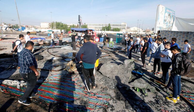 Demonstrators are seen at the place where tents were burned last night during the ongoing anti-government protests in Basra. Reuters