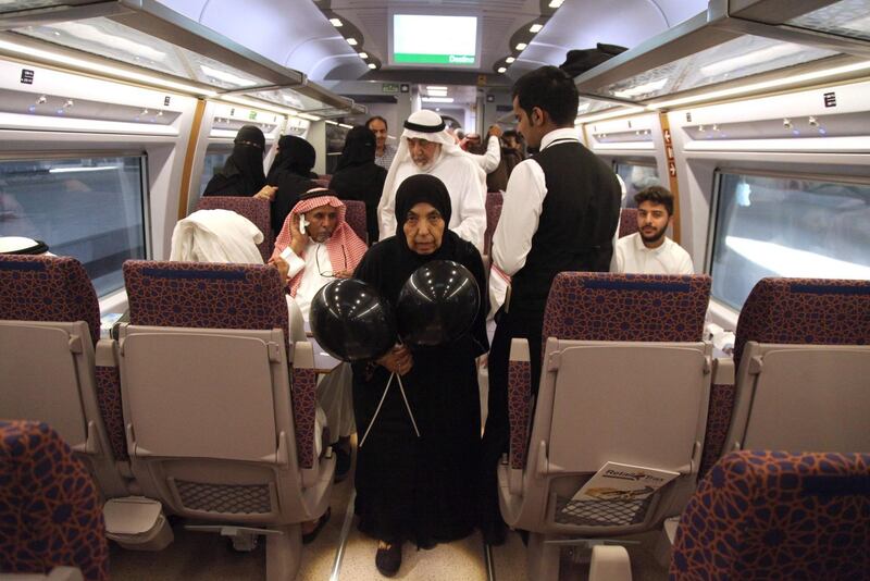 Passengers walk inside the first  train to depart from Makkah on Saudi Arabia's new high-speed railway. AFP