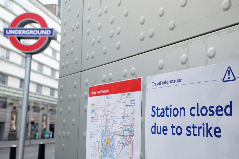 A poster details a separate strike by Tube workers, outside Victoria underground station in London. Reuters