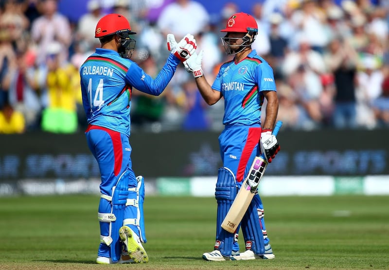 BRISTOL, ENGLAND - JUNE 01: Najibullah Zadran of Afghanistan celebrates his 50 with Gulbadin Naib of Afghanistan during the Group Stage match of the ICC Cricket World Cup 2019 between Afghanistan and Australia at Bristol County Ground on June 01, 2019 in Bristol, England. (Photo by Jordan Mansfield/Getty Images)
