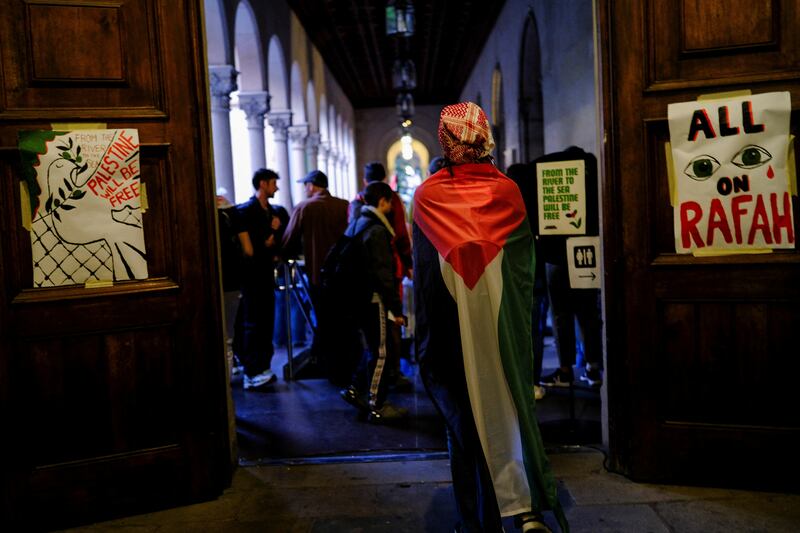 A student of the University of Barcelona wears a Palestinian flag during a protest. Reuters