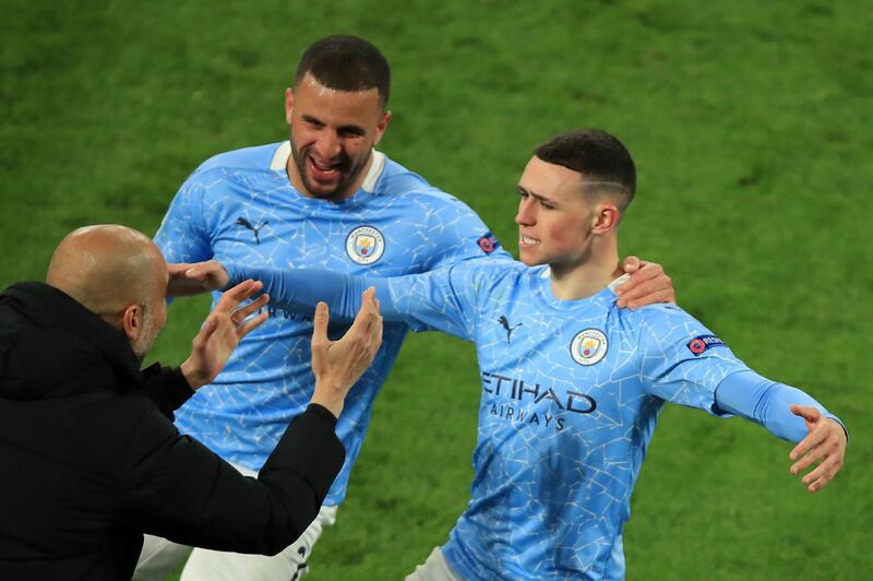 Phil Foden celebrates scoring their second goal with manager Pep Guardiola and Kyle Walker. Reuters