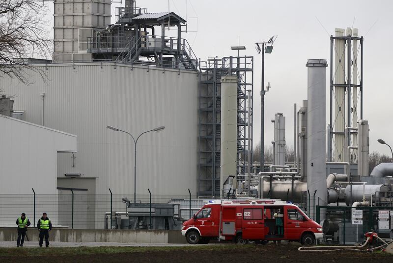 Firefighters stand outside a gas plant after an explosion occurred near Baumgarten. Ronald Zak / AP Photo