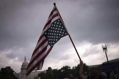 An upside down American flag is raised by supporters of those charged in the January 6 attack on the US Capitol. AFP

