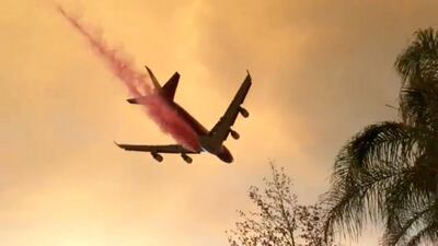 A plane dumps fire retardant over the Holy Fire as it spreads in Lake Elsinore, California, the U.S. August 8, 2018 in this still image taken from a video obtained from social media. Lake Elsinore City Hall/via REUTERS THIS IMAGE HAS BEEN SUPPLIED BY A THIRD PARTY. MANDATORY CREDIT. NO RESALES. NO ARCHIVES.